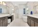 Bright bathroom featuring a glass-enclosed shower, soaking tub, and double vanity with white countertop at 8812 S Bay Dr, Orlando, FL 32819