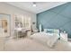 Bright bedroom with a stylish blue accent wall, desk, and large window at 8812 S Bay Dr, Orlando, FL 32819