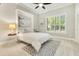 Comfortable bedroom with a large window, soft carpet, and neutral color palette at 8812 S Bay Dr, Orlando, FL 32819