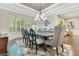 Elegant dining room with tray ceiling, chandelier, and large windows for natural light at 8812 S Bay Dr, Orlando, FL 32819