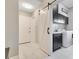 Modern laundry room with sliding barn door, cabinets, and washer and dryer at 8812 S Bay Dr, Orlando, FL 32819