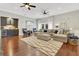 Spacious living room featuring a built-in bar, comfortable seating, and hardwood floors at 8812 S Bay Dr, Orlando, FL 32819