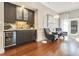 Cozy living area featuring a built-in bar, ample seating, and access to outdoor space at 8812 S Bay Dr, Orlando, FL 32819