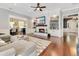 Inviting living room with hardwood floors, a fireplace, built-in shelves, and seamless access to other rooms at 8812 S Bay Dr, Orlando, FL 32819