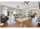 Bright living room with hardwood floors, French doors, and an open layout to the dining area at 8812 S Bay Dr, Orlando, FL 32819