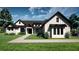 Stunning home featuring a modern design with a lush green lawn and beautiful landscaping at 9940 Black Bear Ln, Winter Garden, FL 34787