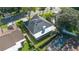 Aerial view of home with a dark roof, screen enclosed pool, and well-maintained landscaping at 1013 Silcox Branch Cir, Oviedo, FL 32765