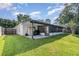 Backyard featuring the rear of the house, enclosed patio, lawn and privacy fence at 1013 Silcox Branch Cir, Oviedo, FL 32765