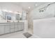 Bright bathroom featuring a glass enclosed shower, double vanity and marble countertops at 1013 Silcox Branch Cir, Oviedo, FL 32765