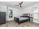 Neutral bedroom with ceiling fan, hardwood floors, and a large window with curtains at 1013 Silcox Branch Cir, Oviedo, FL 32765