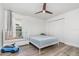 Bright bedroom featuring hardwood floors, a ceiling fan and a large closet at 1013 Silcox Branch Cir, Oviedo, FL 32765