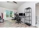 Bright bonus room featuring gym equipment, a large desk, and hardwood floors at 1013 Silcox Branch Cir, Oviedo, FL 32765