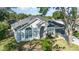 Charming front exterior featuring a landscaped yard, arched entrance, and attached garage at 1013 Silcox Branch Cir, Oviedo, FL 32765