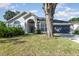 Charming single-story home with a well-maintained lawn and beautiful front yard landscaping at 1013 Silcox Branch Cir, Oviedo, FL 32765