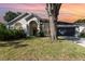 Charming single-story home with a well-maintained lawn and beautiful front yard landscaping at 1013 Silcox Branch Cir, Oviedo, FL 32765