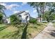Beautiful single-story home with well-kept lawn and mature landscaping with a sidewalk on the street at 1013 Silcox Branch Cir, Oviedo, FL 32765