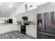 Bright kitchen featuring stainless steel appliances, granite counters, and stylish gray and white cabinetry at 1013 Silcox Branch Cir, Oviedo, FL 32765