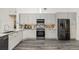 Modern kitchen with stainless steel appliances, granite countertops, and sleek grey cabinets at 1013 Silcox Branch Cir, Oviedo, FL 32765