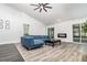 Bright living room featuring vaulted ceilings, modern fireplace, and sliding glass doors to the lanai at 1013 Silcox Branch Cir, Oviedo, FL 32765