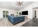 Open living room featuring a ceiling fan, large TV, and sliding glass doors to the outdoor space at 1013 Silcox Branch Cir, Oviedo, FL 32765
