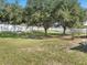 Large backyard with mature trees, offering plenty of space for outdoor activities at 10247 Mason Loop, Clermont, FL 34711