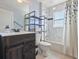 Bathroom featuring a toilet, sink vanity, and shower-over-tub combo at 10247 Mason Loop, Clermont, FL 34711