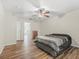Bedroom with a ceiling fan and a dresser with an en suite bathroom entrance at 10247 Mason Loop, Clermont, FL 34711