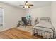 This bedroom features wood laminate flooring, ceiling fan, desk and computer at 10247 Mason Loop, Clermont, FL 34711