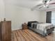Spacious bedroom with wood laminate flooring, a ceiling fan, and dresser at 10247 Mason Loop, Clermont, FL 34711