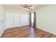 Bedroom with wood floors, neutral walls, and natural light at 10247 Mason Loop, Clermont, FL 34711
