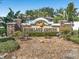 Highland Groves community sign surrounded by lush landscaping and stone accents at 10247 Mason Loop, Clermont, FL 34711
