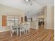 Inviting dining area featuring wood floors, natural light from the window, and a table set for a cozy Gathering meal at 10247 Mason Loop, Clermont, FL 34711
