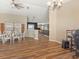 Open-concept dining area with wood floors, connected to the living room and kitchen creating a versatile living space at 10247 Mason Loop, Clermont, FL 34711