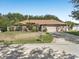Charming single-story home featuring a well-manicured lawn, a two-car garage, and mature trees in a suburban neighborhood at 10247 Mason Loop, Clermont, FL 34711
