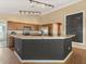 A large kitchen with stainless steel appliances, an island, and a large chalkboard at 10247 Mason Loop, Clermont, FL 34711
