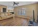 Bright living room features wood laminate flooring and a large window at 10247 Mason Loop, Clermont, FL 34711