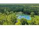 Beautiful aerial view of property with tennis courts, clubhouse and river access amidst a lush, green forest at 107 Wayland Cir, Longwood, FL 32779