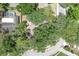 Aerial shot of the home's roof, landscaping, and the surrounding neighborhood's tree coverage at 107 Wayland Cir, Longwood, FL 32779