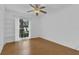 Inviting bedroom highlighting wood floors, a built-in bookshelf, and natural light at 107 Wayland Cir, Longwood, FL 32779