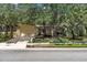 Charming home featuring a stone facade, attached garage, driveway, and well-manicured front yard at 107 Wayland Cir, Longwood, FL 32779