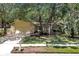Charming single-story home with a manicured front lawn, mature trees, and a two-car garage at 107 Wayland Cir, Longwood, FL 32779