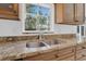 Close-up of kitchen sink area showcasing granite countertops and stainless steel faucet at 107 Wayland Cir, Longwood, FL 32779