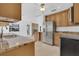 Bright kitchen with stainless steel appliances and a view into a Gathering room with a fireplace at 107 Wayland Cir, Longwood, FL 32779