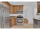 Close-up of the kitchen featuring stainless steel appliances and wooden cabinetry at 107 Wayland Cir, Longwood, FL 32779