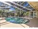 Beautiful pool area with screened enclosure surrounded by lush landscaping at 107 Wayland Cir, Longwood, FL 32779