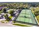 Aerial view of multiple tennis courts with lighting and parking, providing ample recreational space at 107 Wayland Cir, Longwood, FL 32779