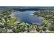 An aerial view of waterfront houses on a lake shows boat docks, and lake vegetation at 1113 Hawthorne Cove Dr, Ocoee, FL 34761