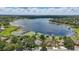 A stunning aerial view shows the lake, lily pads, and homes at 1113 Hawthorne Cove Dr, Ocoee, FL 34761