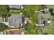 Stunning aerial view of property showcasing pool, lush landscaping, and private boat dock on tranquil lake at 1113 Hawthorne Cove Dr, Ocoee, FL 34761