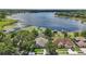 Aerial view of lake community with waterfront houses, and clear view of a lake at 1113 Hawthorne Cove Dr, Ocoee, FL 34761